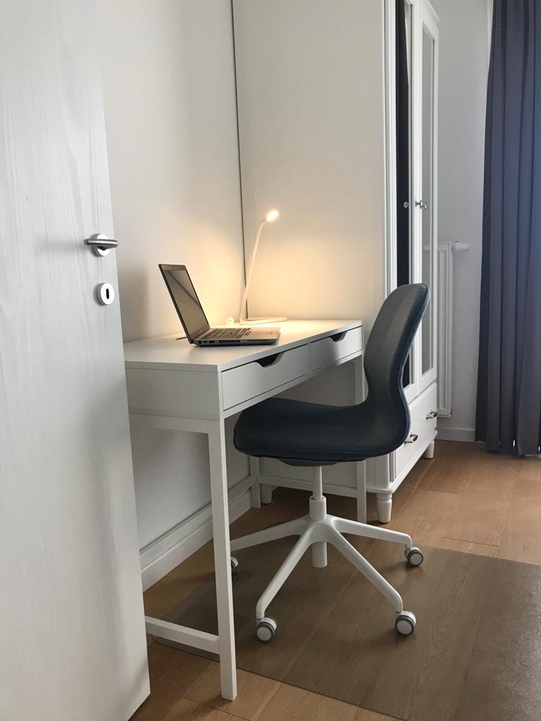 The desk and chair by the window, set up for a morning's work.